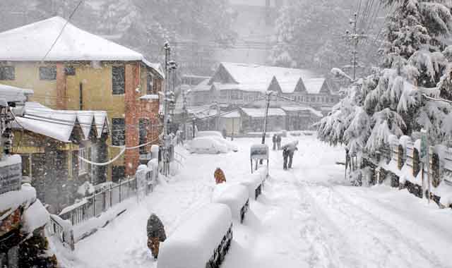A snow covered street and shops in Dalhousie.